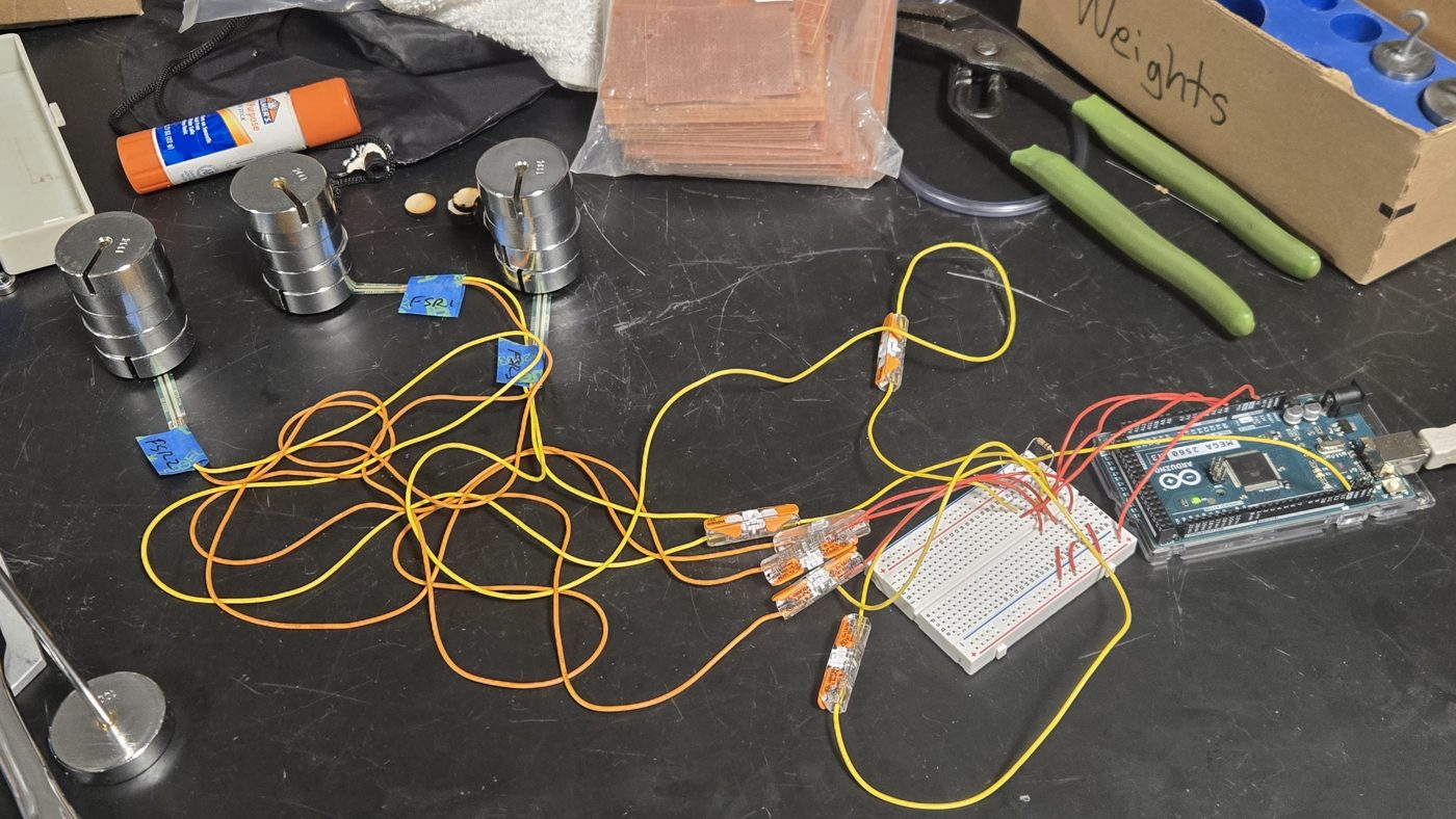 FSR array, Arduino, and calibration weights on the bench