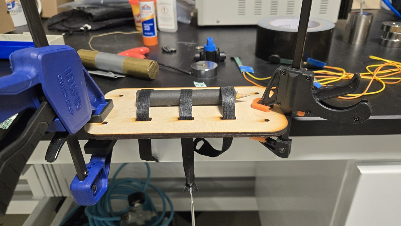 Strap splint clamped to a bench with a hanging mass